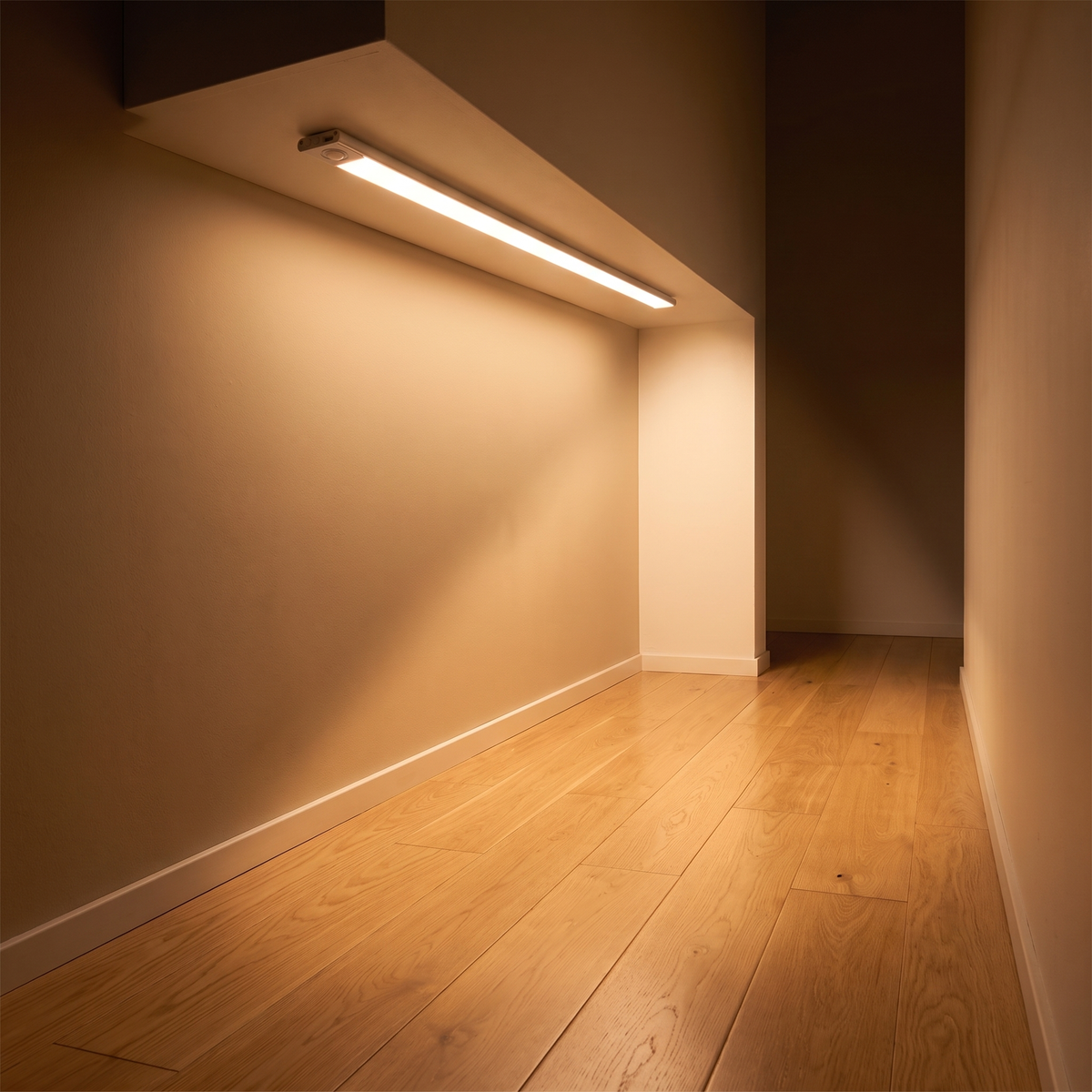 Motion sensor strip light glowing softly along a hallway wall at night