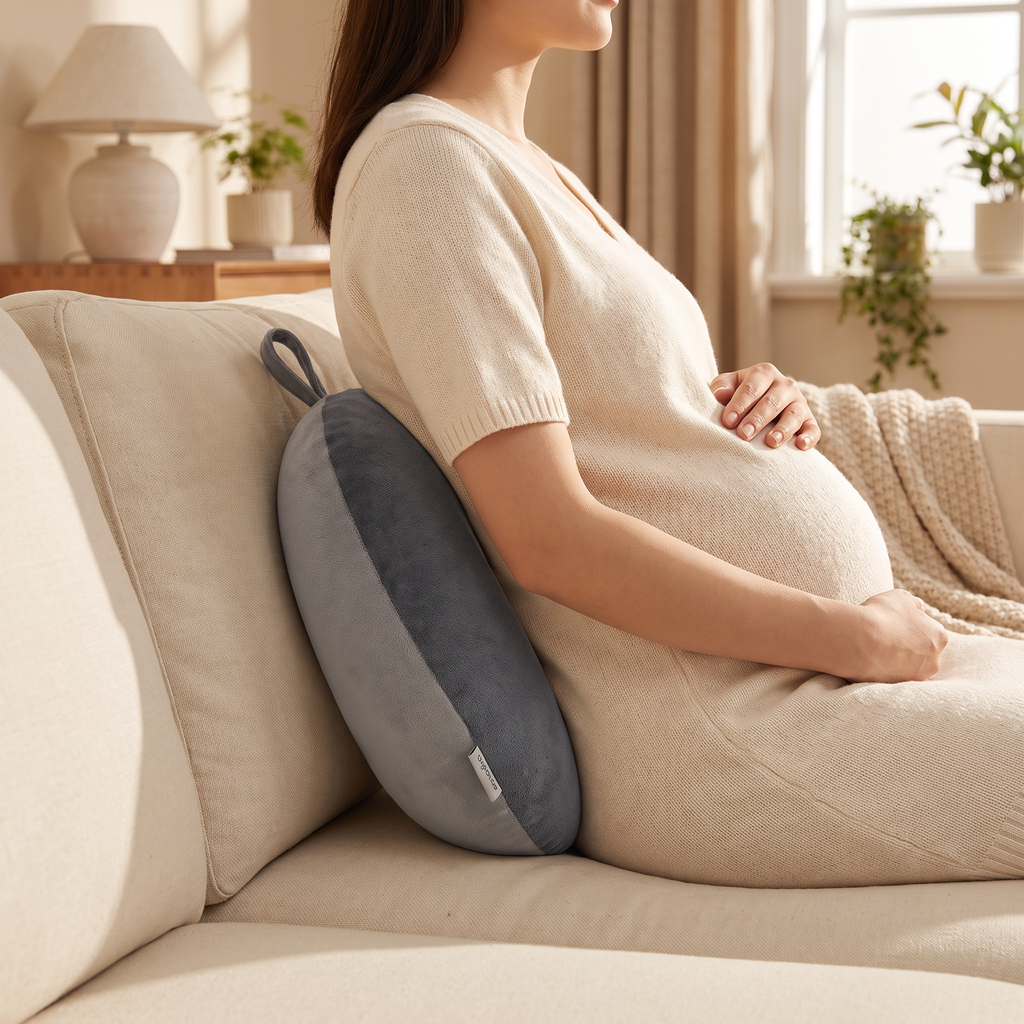 Bead-filled bolster supporting the lower back of a pregnant woman seated on a sofa
