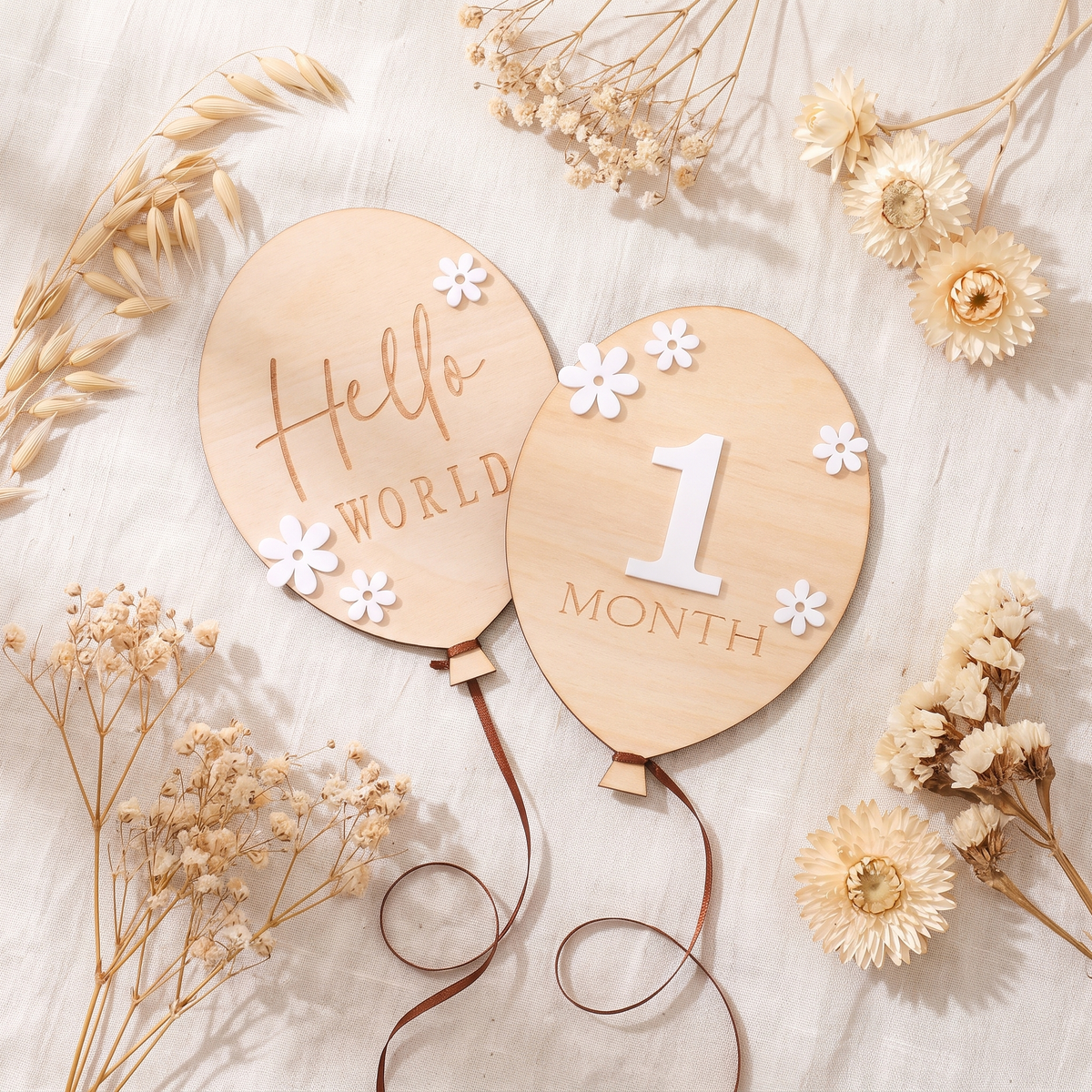 Wooden milestone cards flat lay with dried flowers on cream linen